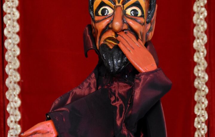 Hand-carved wooden devil puppet Berlichet with horns, pointed black beard, red skin, and satin cape from the private collection of puppeteer Fulvia Marai