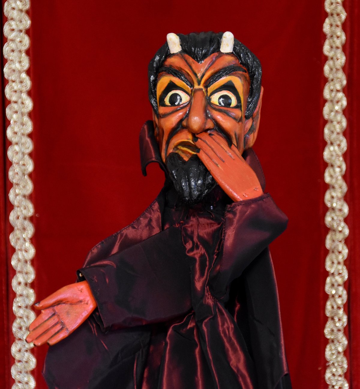 Hand-carved wooden devil puppet Berlichet with horns, pointed black beard, red skin, and satin cape from the private collection of puppeteer Fulvia Marai