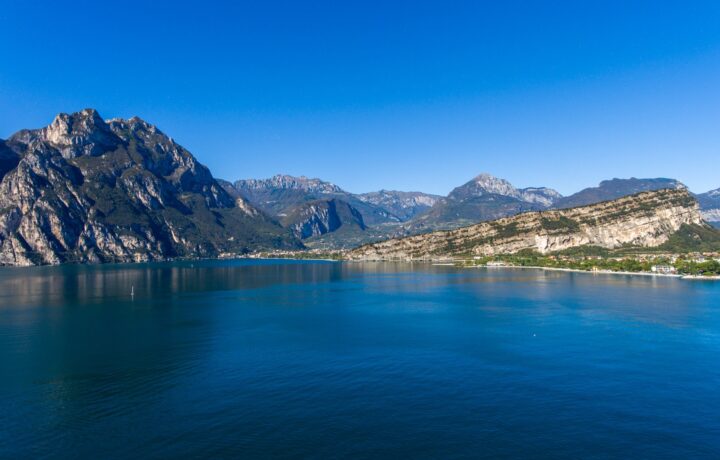 Aerial drone photograph of Trimelone Island fortress off the shoreline of Assenza di Brenzone on Lake Garda