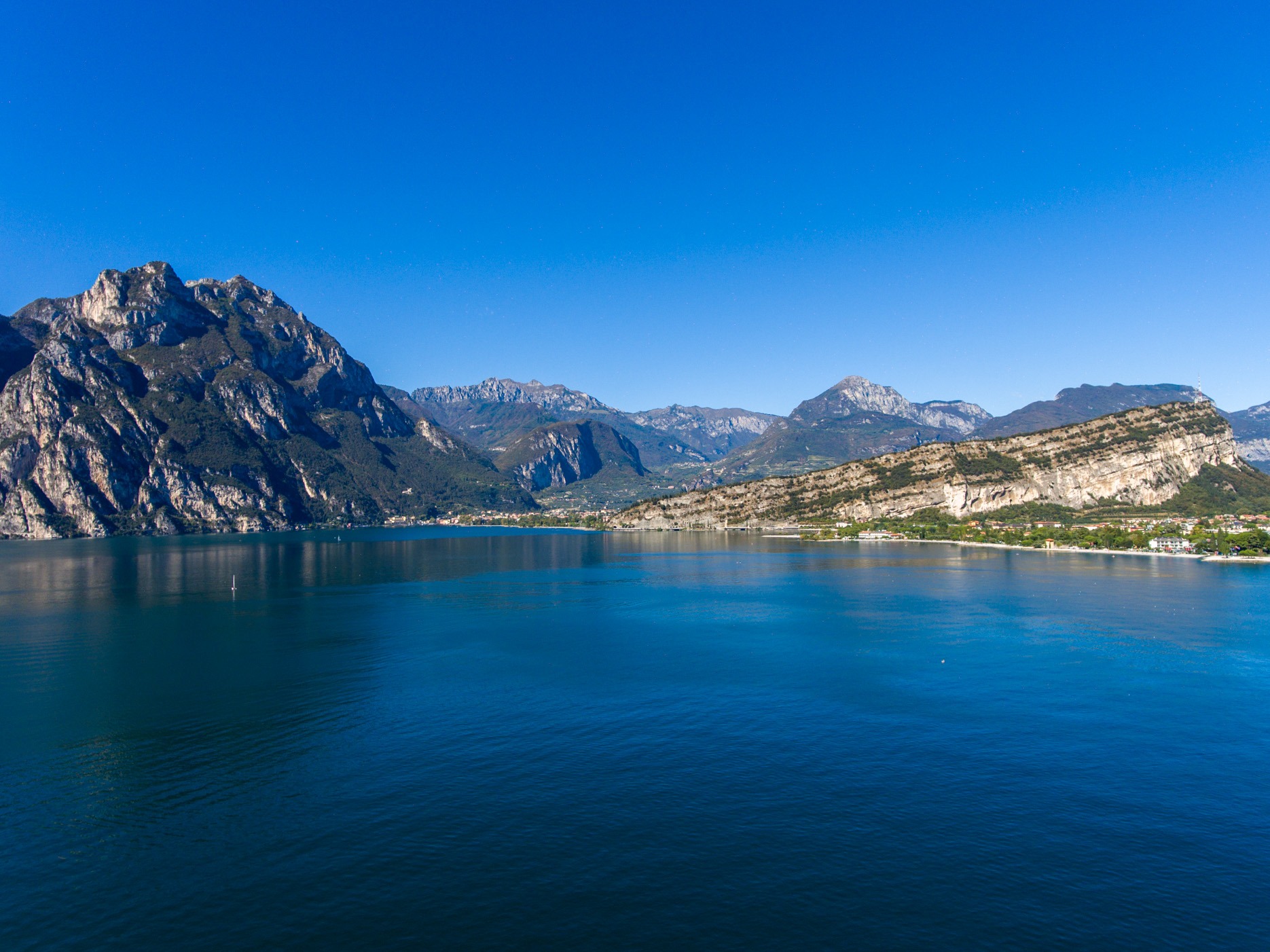 Aerial drone photograph of Trimelone Island fortress off the shoreline of Assenza di Brenzone on Lake Garda