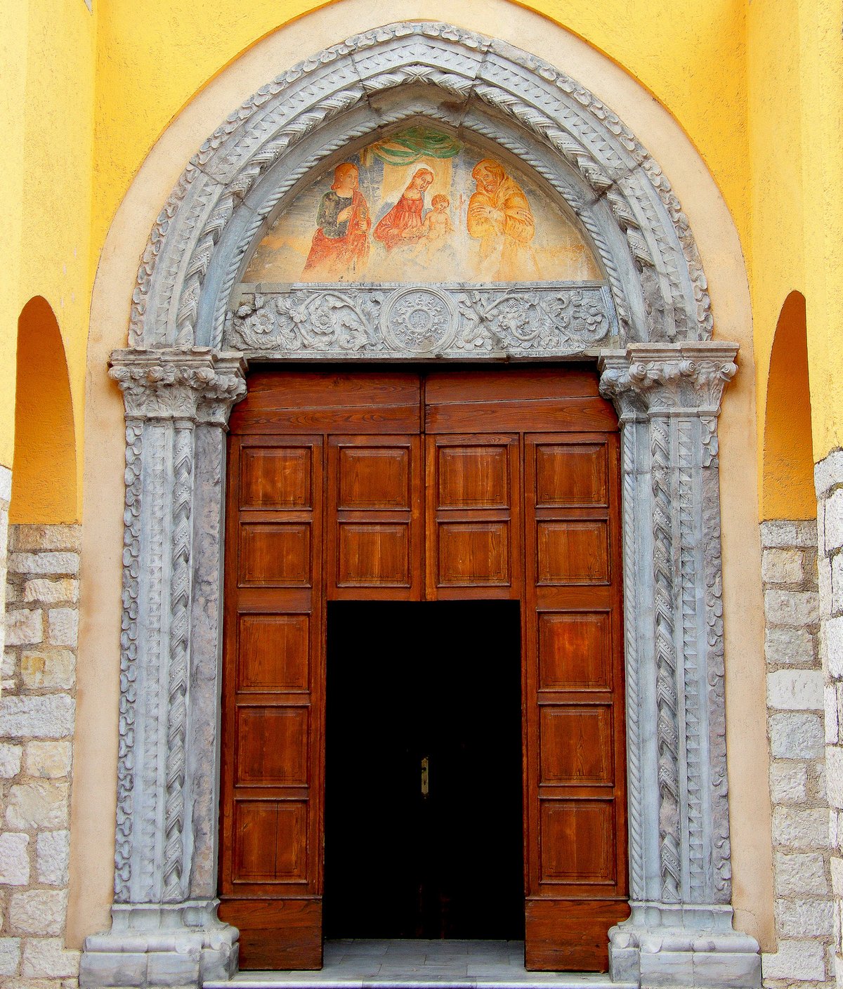 Carved portal and fresco lunette at the Capuchin church of Barbarano