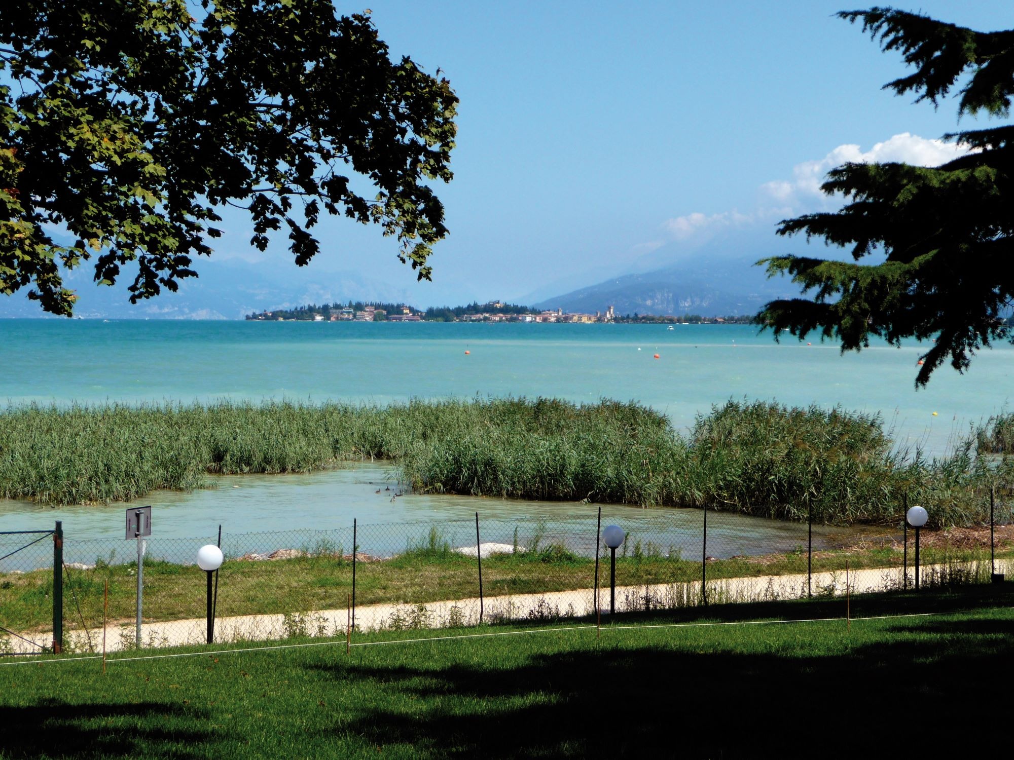 Panoramic expanse of Lake Garda basin framed by the surrounding morainic hills and mountain ridges