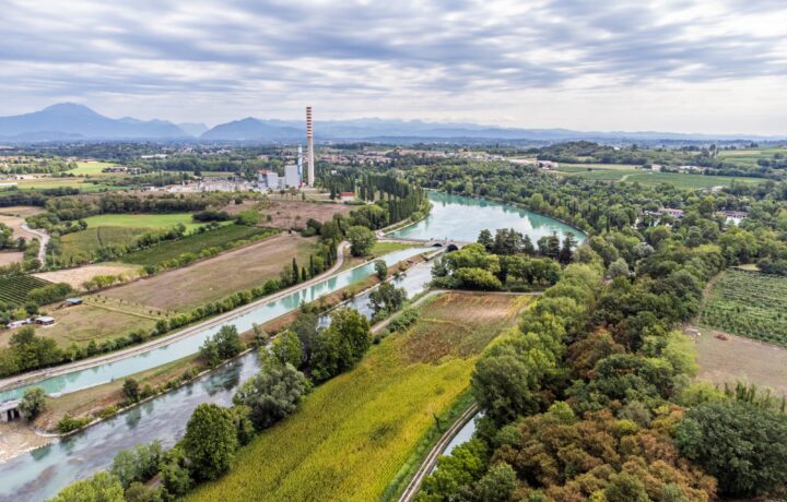 Aerial panorama of Salionze Dam controlling Mincio River outflow south of Lake Garda