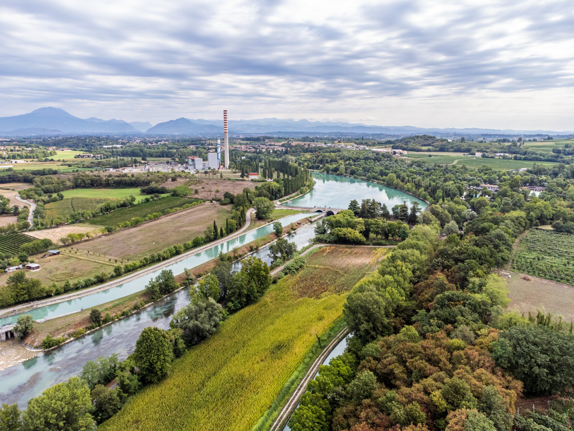 Aerial panorama of Salionze Dam controlling Mincio River outflow south of Lake Garda