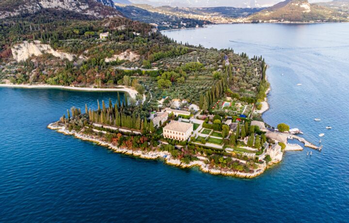 Panoramic landscape view of Punta San Vigilio headland and Monte Luppia ridge above Lake Garda