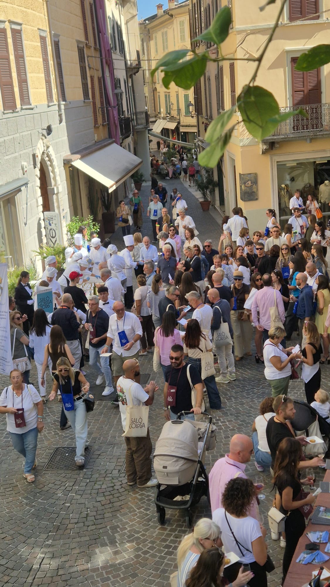 People enjoying food and wine tasting during the Salò Golosa event in the historic centre of Salò